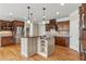 Well-equipped kitchen featuring an island, wooden cabinets, granite countertops, and stainless-steel appliances at 2602 Alcovy Club Dr, Dacula, GA 30019