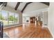 Open-concept living room featuring hardwood floors, large windows, and view to kitchen with stainless steel appliances at 2602 Alcovy Club Dr, Dacula, GA 30019