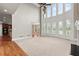 Open living room featuring a fireplace, hardwood floors, and a view of the kitchen at 2602 Alcovy Club Dr, Dacula, GA 30019