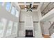 Open living room with tall windows, fireplace, and built-in cabinets at 2602 Alcovy Club Dr, Dacula, GA 30019