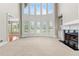 Bright living room showcasing a fireplace and large windows offering lots of natural light at 2602 Alcovy Club Dr, Dacula, GA 30019