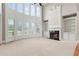 Spacious living room with fireplace, built-in shelving, and large windows at 2602 Alcovy Club Dr, Dacula, GA 30019