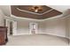 Large Primary bedroom with tray ceiling, fan and doorways to other rooms at 2602 Alcovy Club Dr, Dacula, GA 30019
