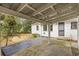 Covered back patio with greenery and patio furniture at 1631 Dresden Ne Dr, Brookhaven, GA 30319