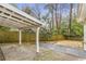 A serene backyard featuring a covered patio, gravel ground cover and a wood privacy fence at 1631 Dresden Ne Dr, Brookhaven, GA 30319