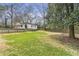 A spacious backyard with a mix of lush grass and mature trees, enclosed by a classic wood fence at 1631 Dresden Ne Dr, Brookhaven, GA 30319