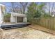 Brick backyard patio with a view of the detached garage and wood privacy fence at 1631 Dresden Ne Dr, Brookhaven, GA 30319