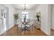 Traditional dining room features hardwood floors, chandelier, and bright light from a window at 1631 Dresden Ne Dr, Brookhaven, GA 30319