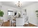 Bright dining room open to living room, with hardwood floors and a chandelier lighting it at 1631 Dresden Ne Dr, Brookhaven, GA 30319