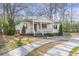 Charming cottage-style home with a quaint front porch, enhanced by freshly cut green grass at 1631 Dresden Ne Dr, Brookhaven, GA 30319