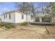 An exterior view of the home showing the back of the house and the detached garage with wooden patio at 1631 Dresden Ne Dr, Brookhaven, GA 30319