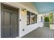 Elegant front porch with blue ceiling, gray door, and black-trimmed windows at 1631 Dresden Ne Dr, Brookhaven, GA 30319