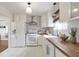 Well-lit kitchen with modern white cabinets, butcher block counters and white appliances at 1631 Dresden Ne Dr, Brookhaven, GA 30319