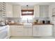 Renovated kitchen with white cabinets, butcher block counters, farmhouse sink and modern appliances at 1631 Dresden Ne Dr, Brookhaven, GA 30319