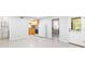 Open basement featuring kitchenette, bathroom, bedroom, tile flooring, and walkout access at 8073 Ridge Vly, Woodstock, GA 30189
