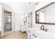 Bathroom with double vanity, tiled floor, glass shower, and ample lighting at 8073 Ridge Vly, Woodstock, GA 30189