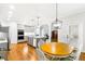 Spacious kitchen and dining area with gray cabinets, stainless appliances, and hardwood floors at 8073 Ridge Vly, Woodstock, GA 30189
