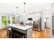 Bright kitchen features an island with seating, stainless steel appliances, and hardwood floors at 8073 Ridge Vly, Woodstock, GA 30189
