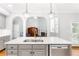 Kitchen island with white countertop, stainless steel sink, and stainless steel dishwasher at 8073 Ridge Vly, Woodstock, GA 30189