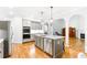 Well-appointed kitchen with hardwood floors, stainless steel appliances and large island at 8073 Ridge Vly, Woodstock, GA 30189
