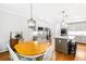 Kitchen includes a dining area, stainless steel appliances, a central island, and gray cabinets at 8073 Ridge Vly, Woodstock, GA 30189