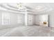 Spacious main bedroom with trey ceiling, fan, carpeted floors, and ensuite bathroom at 8073 Ridge Vly, Woodstock, GA 30189