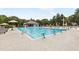 Large swimming pool with lounge chairs and umbrellas, with diving blocks and a nearby clubhouse at 8073 Ridge Vly, Woodstock, GA 30189