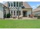 A home's backyard featuring a nice patio with a grilling area, and a pergola-covered seating area at 217 Springs Xing, Canton, GA 30114