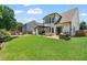 Landscaped backyard featuring stone firepit and patio with pergola, surrounded by well-kept grass at 217 Springs Xing, Canton, GA 30114
