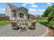 Landscaped backyard featuring stone firepit and patio with pergola, surrounded by well-kept grass at 217 Springs Xing, Canton, GA 30114