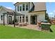 A home's backyard featuring a nice patio with a grilling area, and a pergola-covered seating area at 217 Springs Xing, Canton, GA 30114
