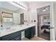 Bathroom with double vanity, large mirror, and doorway to the primary bedroom at 217 Springs Xing, Canton, GA 30114