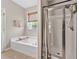 Bright bathroom with soaking tub, shower, and window offering natural light at 217 Springs Xing, Canton, GA 30114