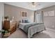 Comfortable bedroom featuring neutral paint, ceiling fan and a bed with many pillows at 217 Springs Xing, Canton, GA 30114