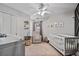 Well-lit Bedroom featuring a crib, chair and changing table at 217 Springs Xing, Canton, GA 30114
