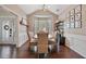 Lovely dining area featuring wainscoting, a large bay window, and a stylish bar area for entertaining guests at 217 Springs Xing, Canton, GA 30114
