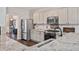 Bright kitchen features stone countertops, stainless steel appliances, and white cabinets at 217 Springs Xing, Canton, GA 30114