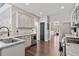 Updated kitchen features stainless steel appliances, stone countertops, and hardwood floors at 217 Springs Xing, Canton, GA 30114