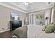 Bright main bedroom with dark wood floors, tray ceilings, ceiling fan and sitting area at 217 Springs Xing, Canton, GA 30114