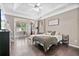 Spacious primary bedroom with hardwood floors, tray ceiling, and large windows at 217 Springs Xing, Canton, GA 30114