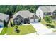 Aerial view of a beautiful home with lush landscaping, three-car garage, and manicured lawn at 2844 Bluestone Sw Dr, Atlanta, GA 30331
