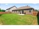Picture of a grassy backyard, a home with brown siding, and a gray concrete patio at 2844 Bluestone Sw Dr, Atlanta, GA 30331