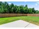 Lush backyard featuring a grassy lawn, a wooden fence, and beautiful trees at 2844 Bluestone Sw Dr, Atlanta, GA 30331