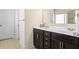 Bathroom features a double sink vanity with dark wood cabinets and a white countertop at 2844 Bluestone Sw Dr, Atlanta, GA 30331