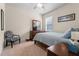 Cozy bedroom with a sleek wooden dresser, a decorative chair, and comfortable blue bedding at 2844 Bluestone Sw Dr, Atlanta, GA 30331