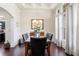 Formal dining room with elegant lighting, dark wood floors, and wainscoting at 2844 Bluestone Sw Dr, Atlanta, GA 30331