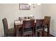 Cozy dining area with wooden table, upholstered chairs, and stylish chandelier at 2844 Bluestone Sw Dr, Atlanta, GA 30331