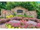 Welcoming entrance to The Summit at Stonewall Tell community with colorful flower beds and stone signage at 2844 Bluestone Sw Dr, Atlanta, GA 30331