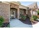 Inviting front entrance with a stone facade, covered porch, and lush landscaping at 2844 Bluestone Sw Dr, Atlanta, GA 30331