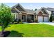 Charming single-story home with a brick facade, manicured lawn, and attached two-car garage at 2844 Bluestone Sw Dr, Atlanta, GA 30331